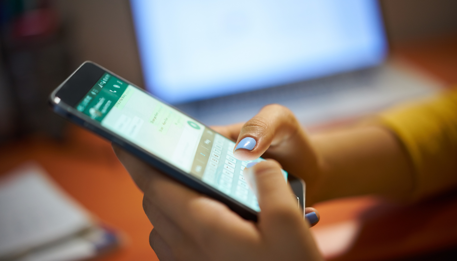 Property manager reviewing guest messages across multiple rental properties at night